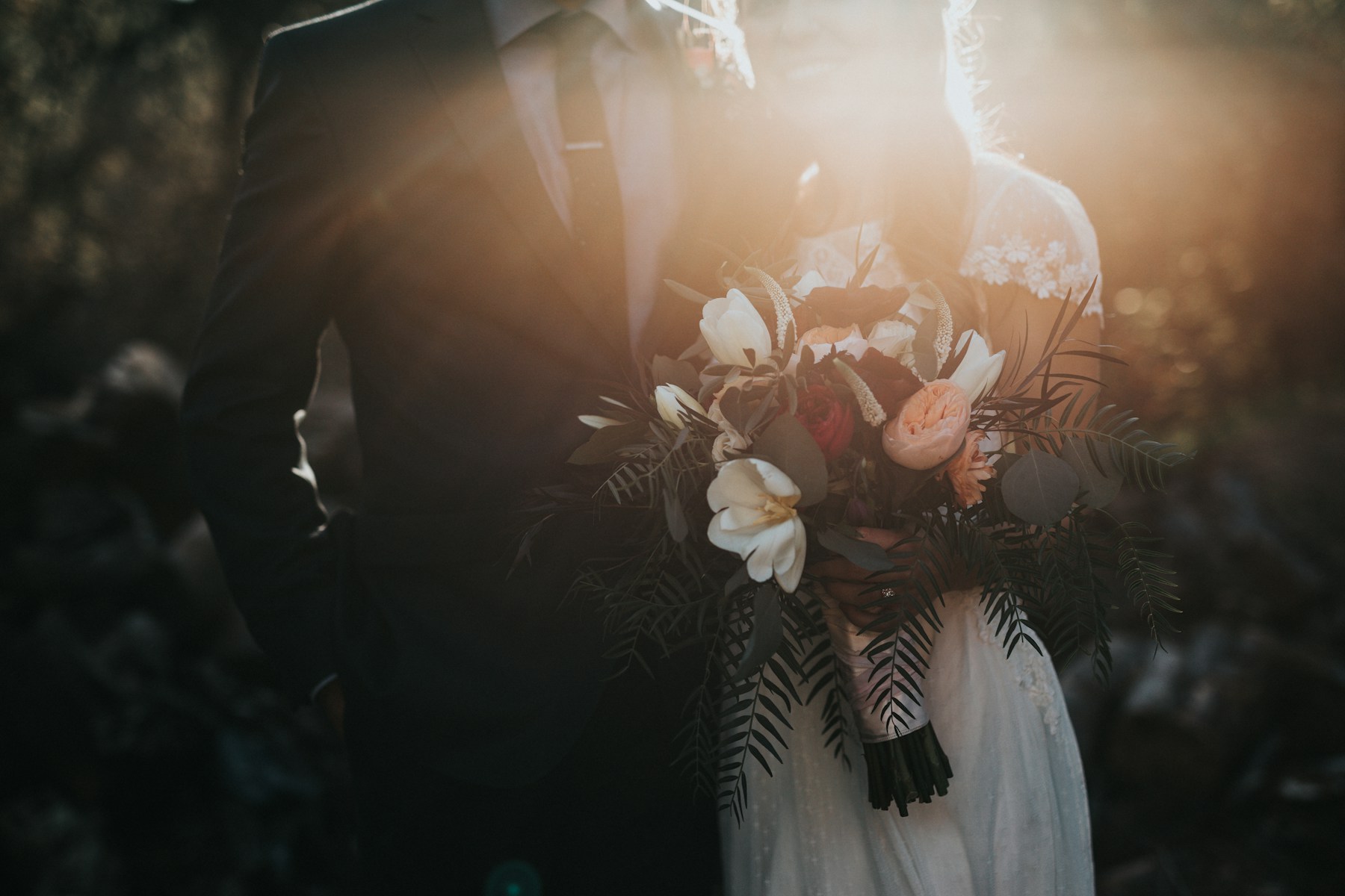 Wedding couple standing together in warm sunset light
